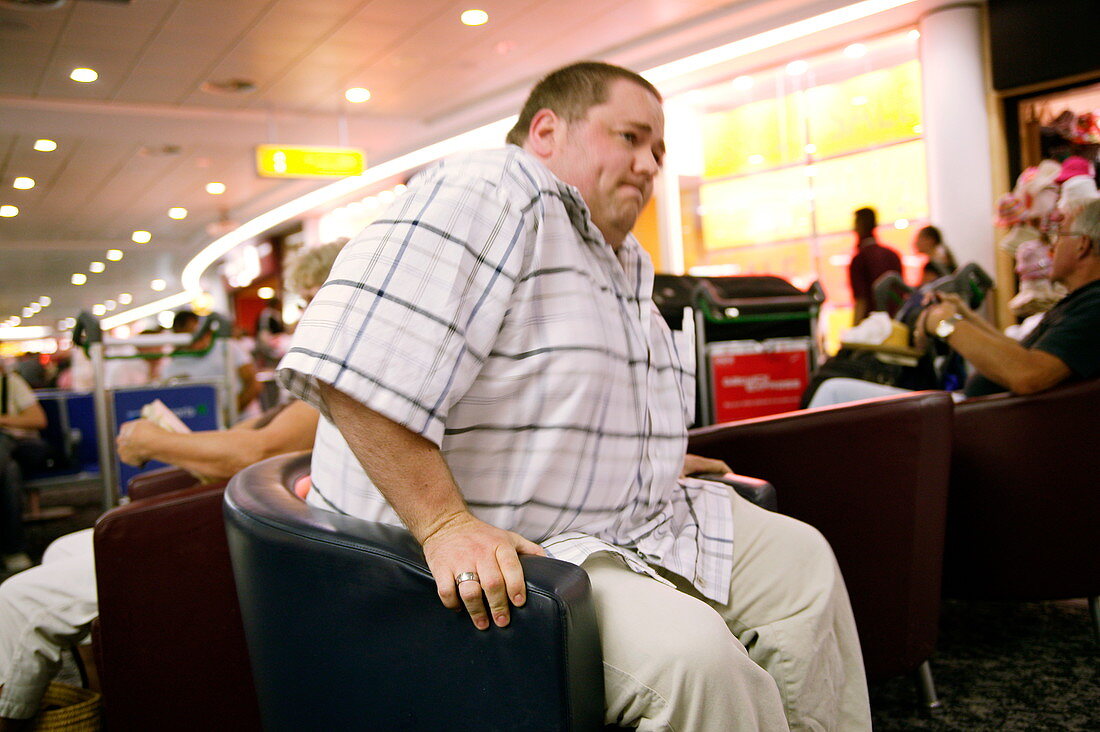Obese man sitting down