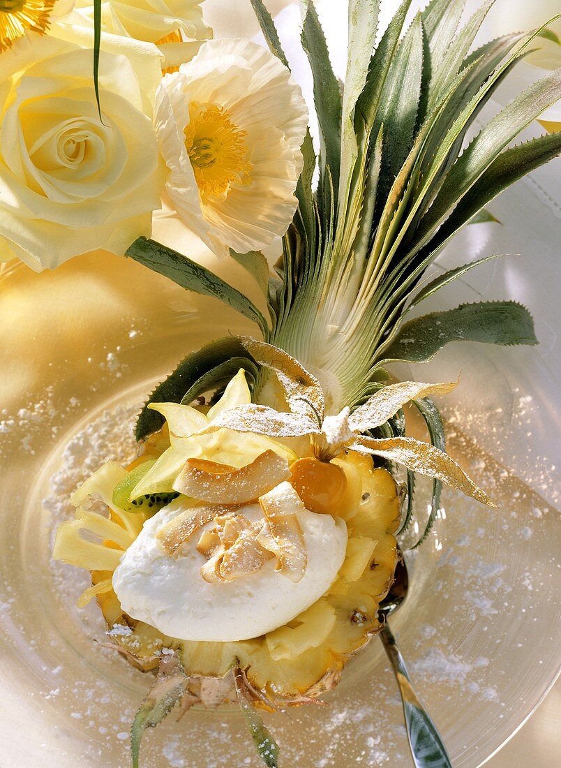 Pineapple half filled with coconut mousse and fruit salad