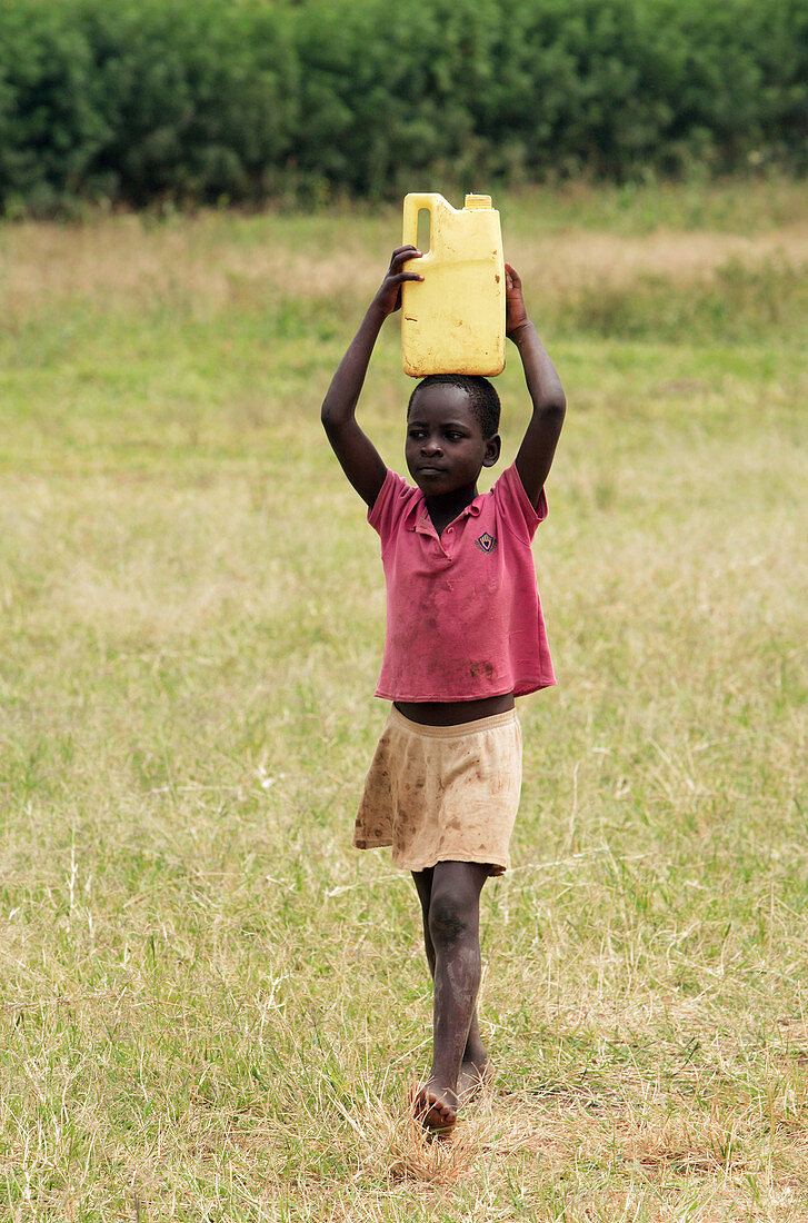 Ugandan boy carrying water