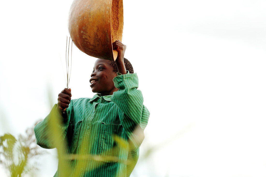 Boy playing an instrument,Uganda