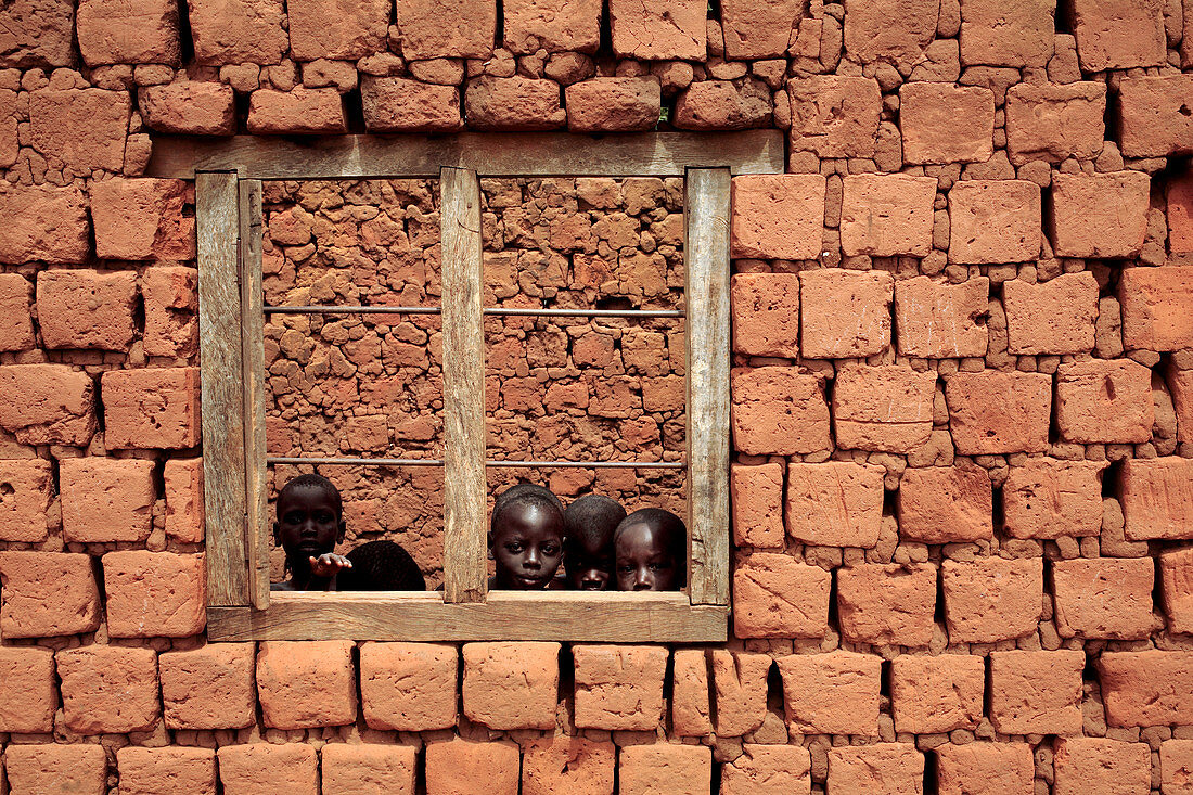 Children looking from a window,Uganda