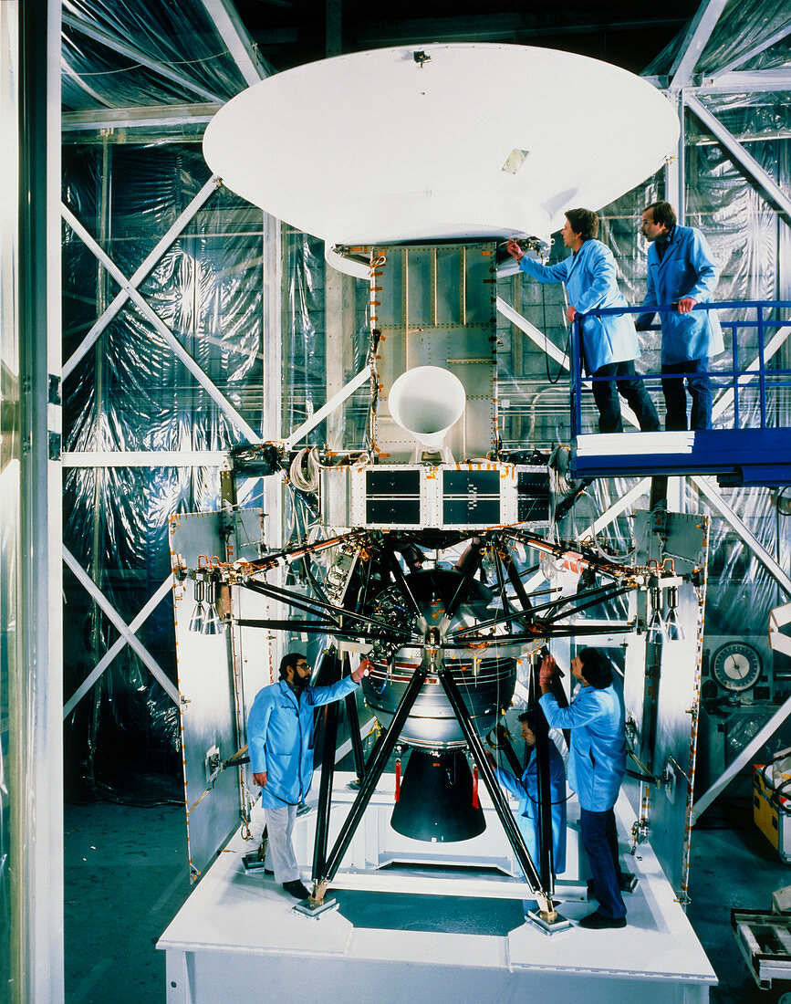Technicians examining the Magellan spacecraft