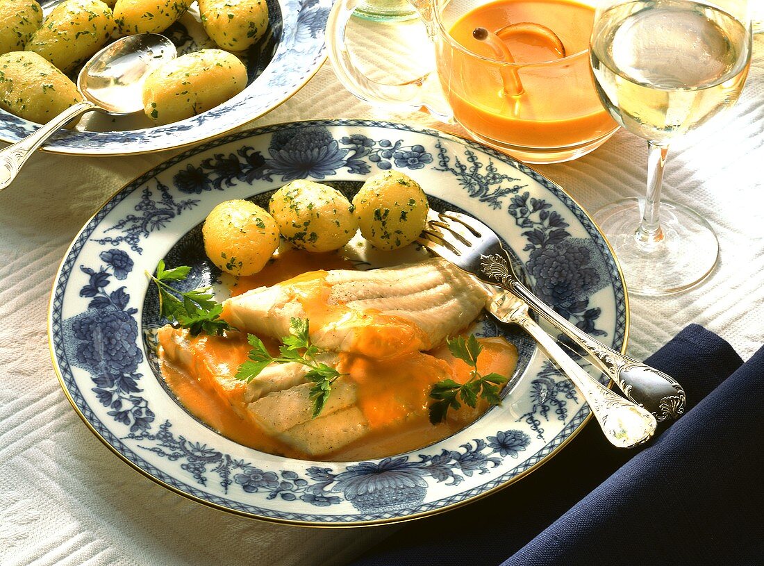 Pike-perch fillets on pepper sauce with parsley potatoes