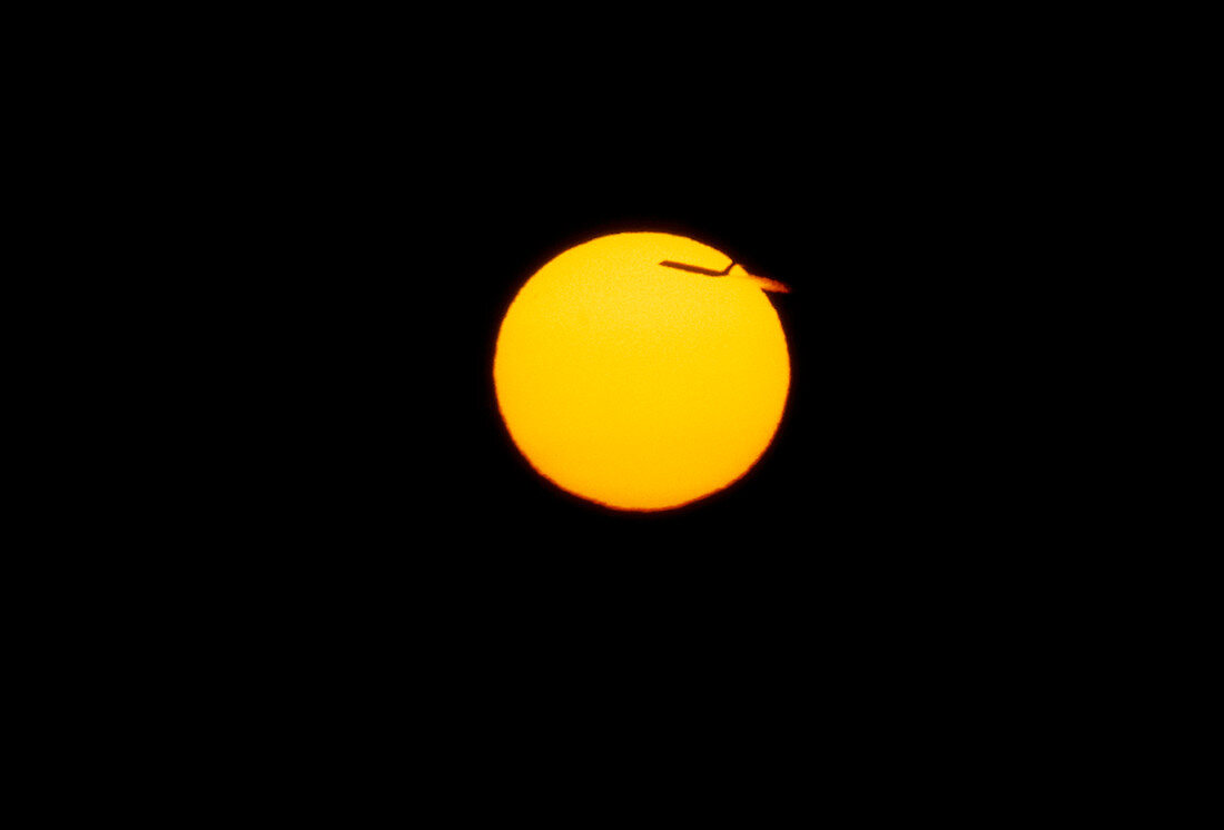 Sun seen at sunset with an aeroplane