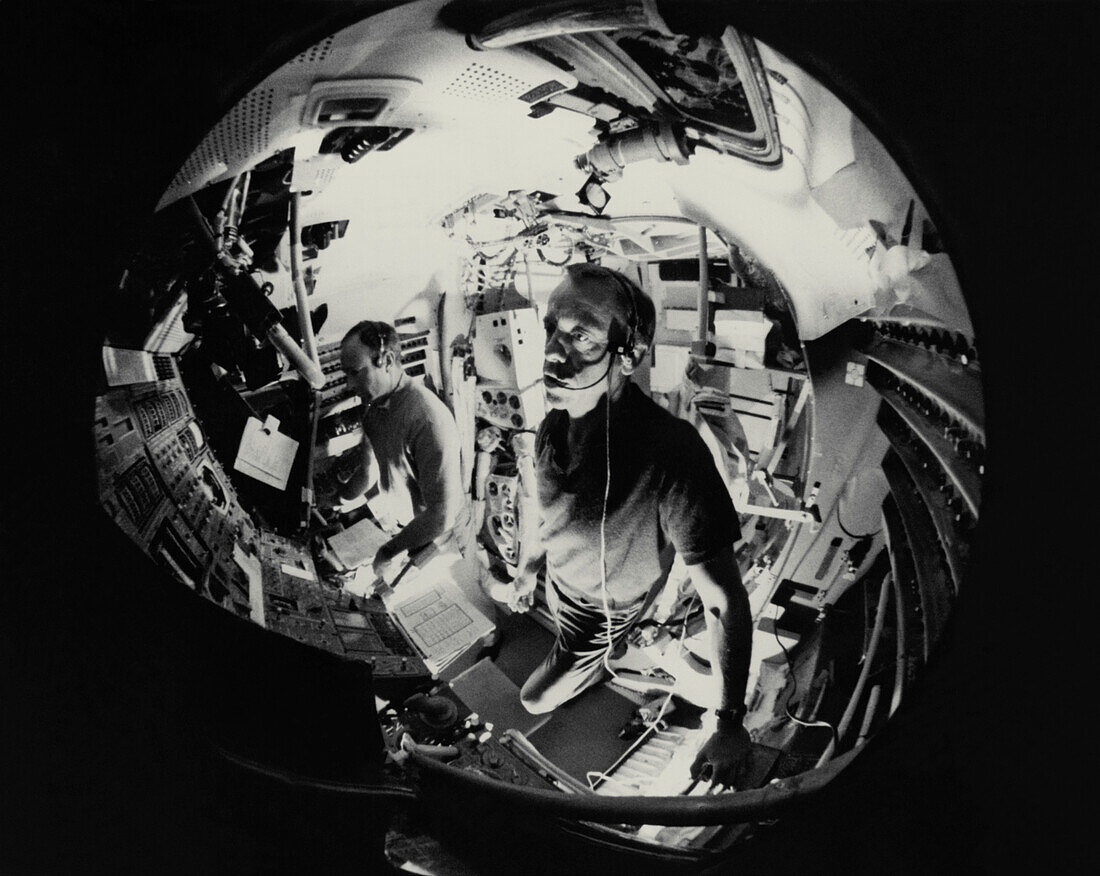 Fish-eyes lens view of 2 astronauts
