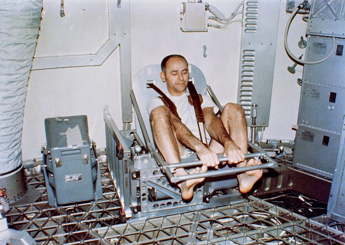 Skylab astronaut in body mass experiment