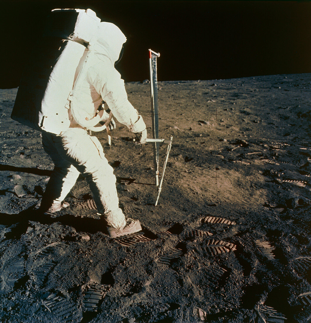 Apollo 11 astronaut Buzz Aldrin taking soil sample