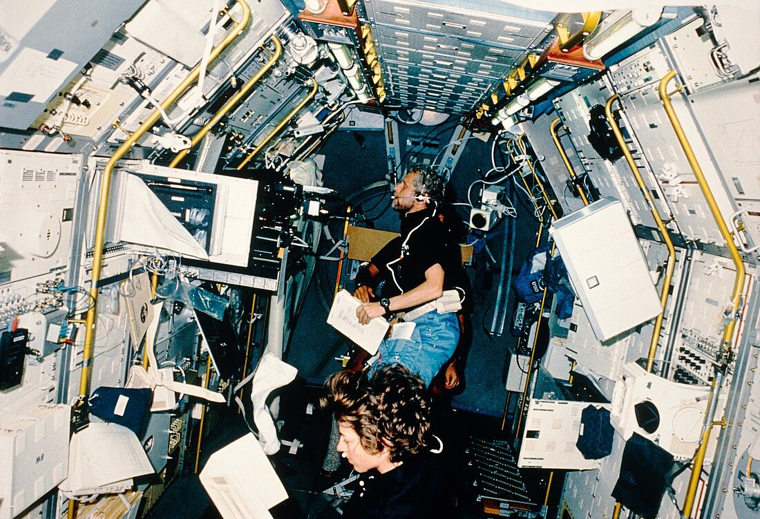 Astronauts working in Spacelab
