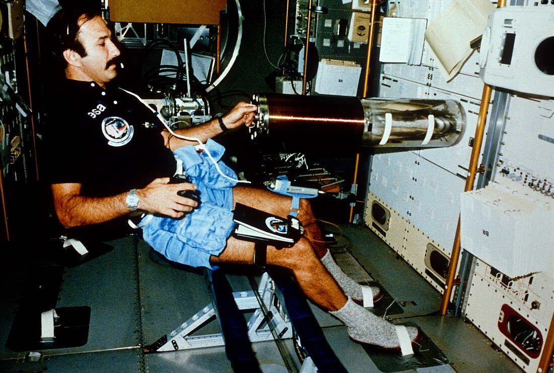 Astronaut performing experiments in Skylab