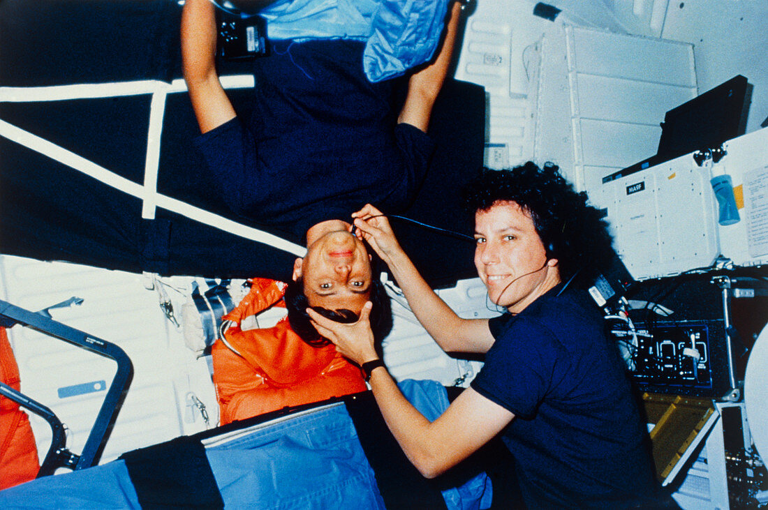 Astronaut performing medical check-ups on crew