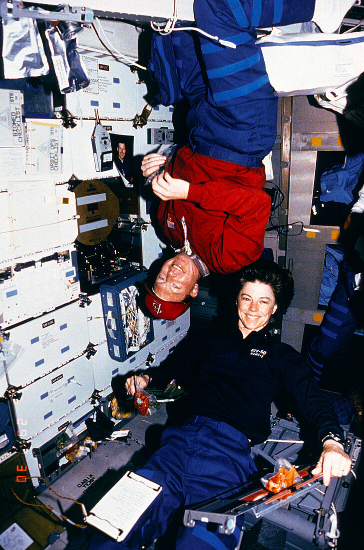 Astronauts Richards and Dunbar eating,STS-50