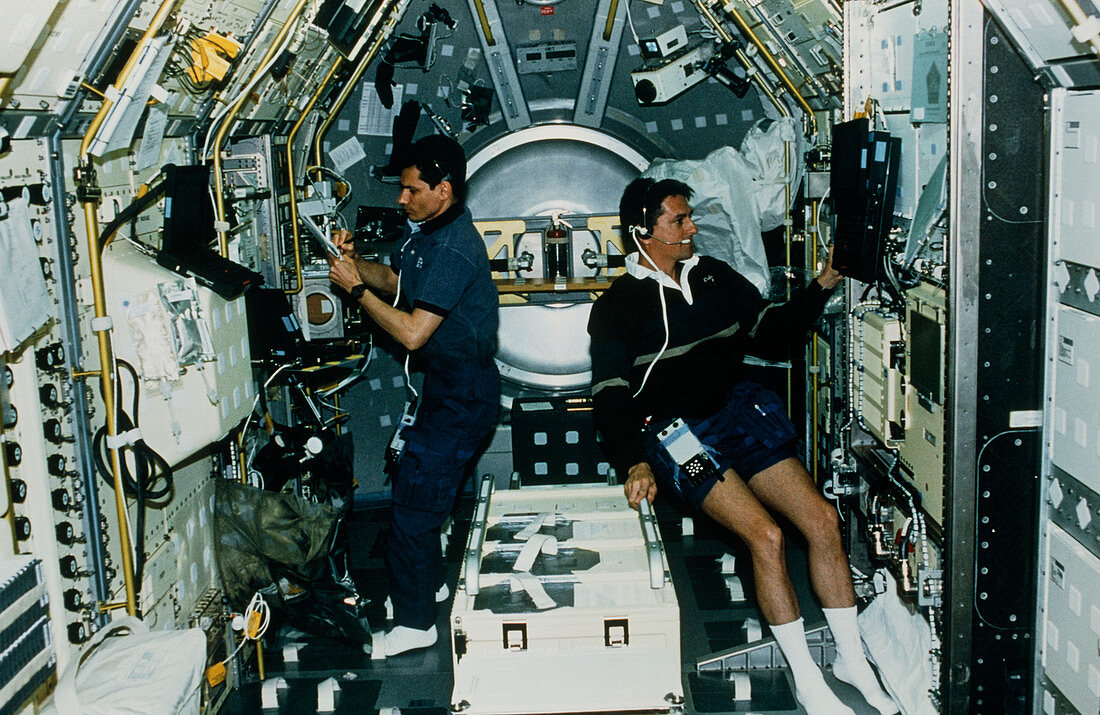 Astronauts experimenting on board shuttle Spacelab