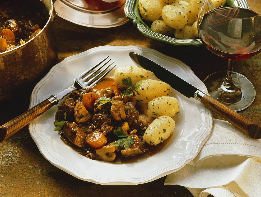 Boeuf Bourguignon with parsley potatoes on plate