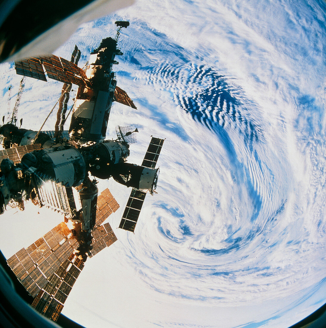 Russian space station Mir over a storm on Earth