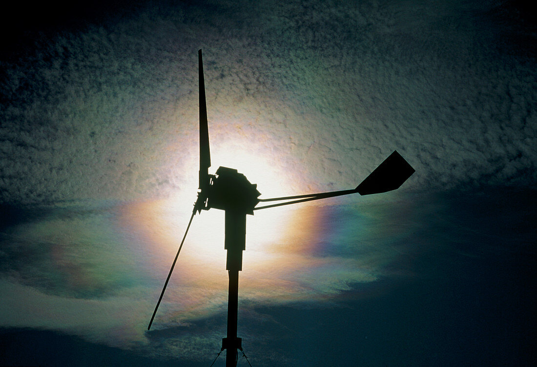 Wind generator silhouette with iridescent clouds