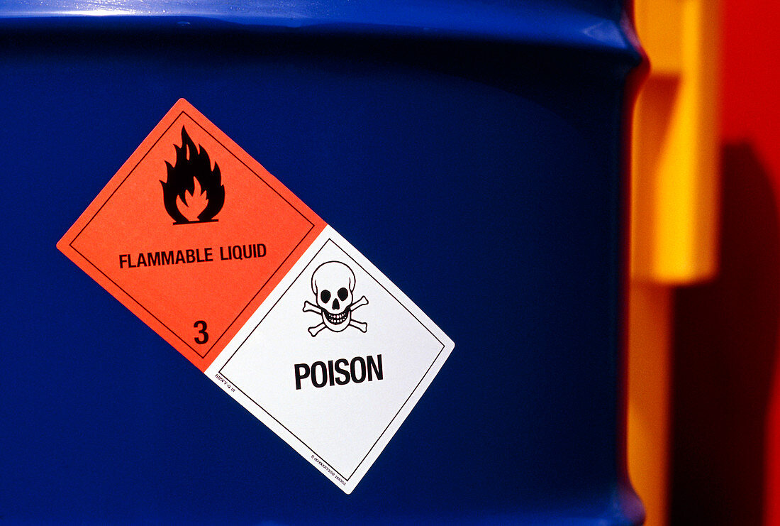 Poison & flammable warning signs on chemical drum