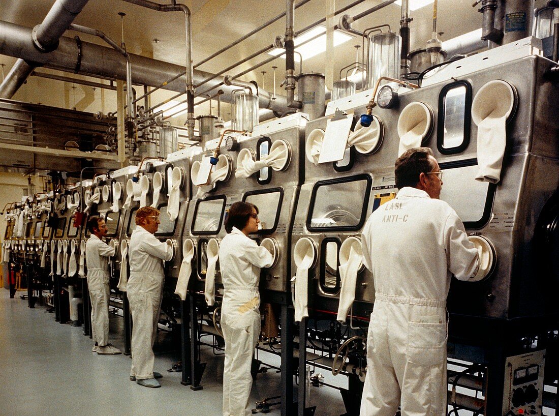Workers using glovebox to handle plutonium