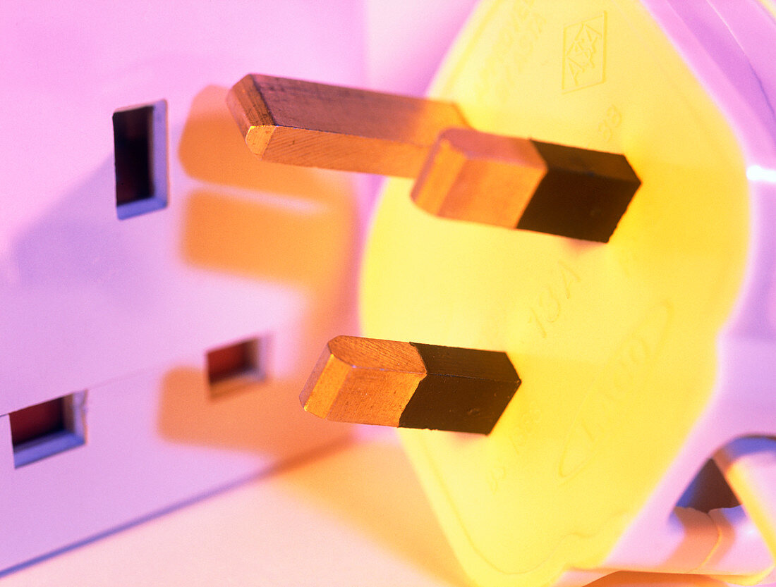 Close-up of a 3-pin electrical plug and socket