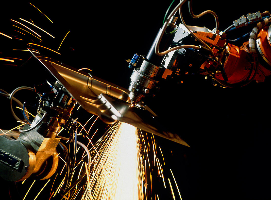 Robot-mounted YAG laser cutting through metal