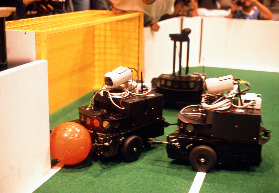 Robots trying to score a goal at RoboCup-98,Paris