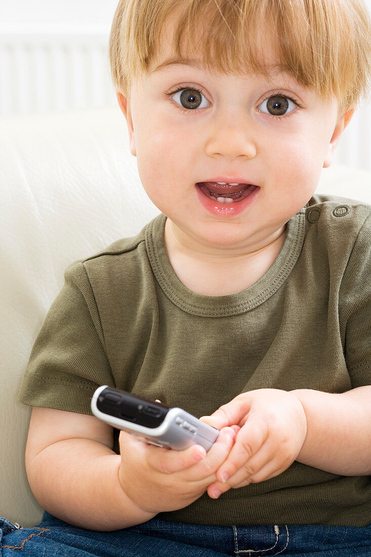 Toddler playing with a mobile phone