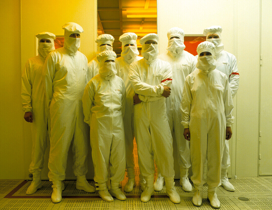 Chip-making technicians in clean-room clothing