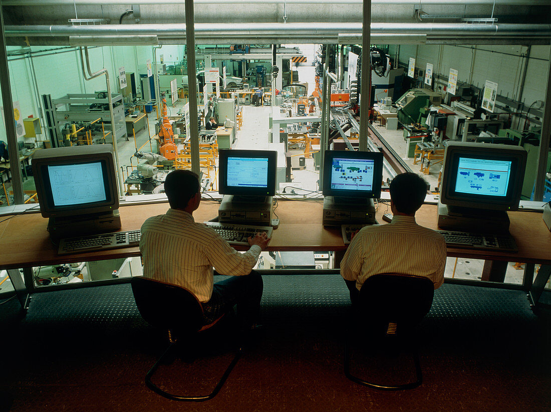 Car factory technicians in a computer control room