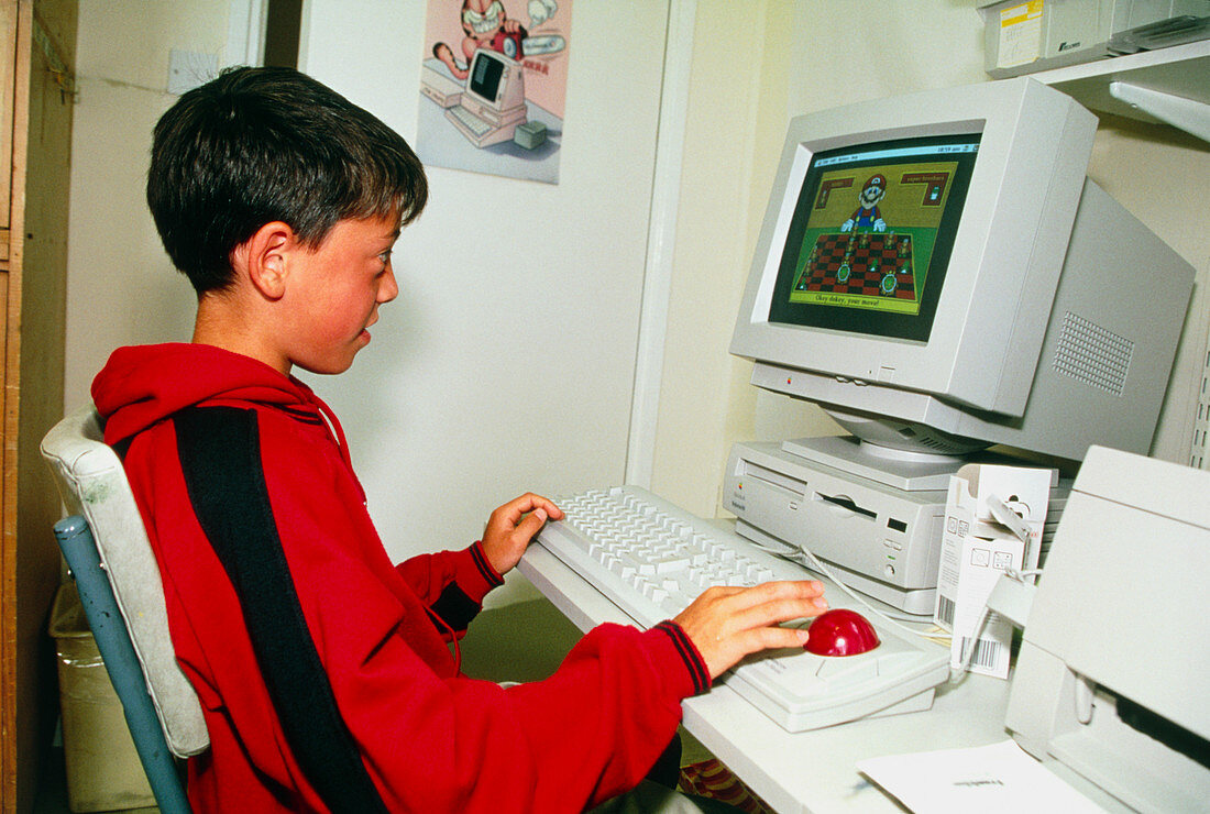 Young boy playing on a personal computer