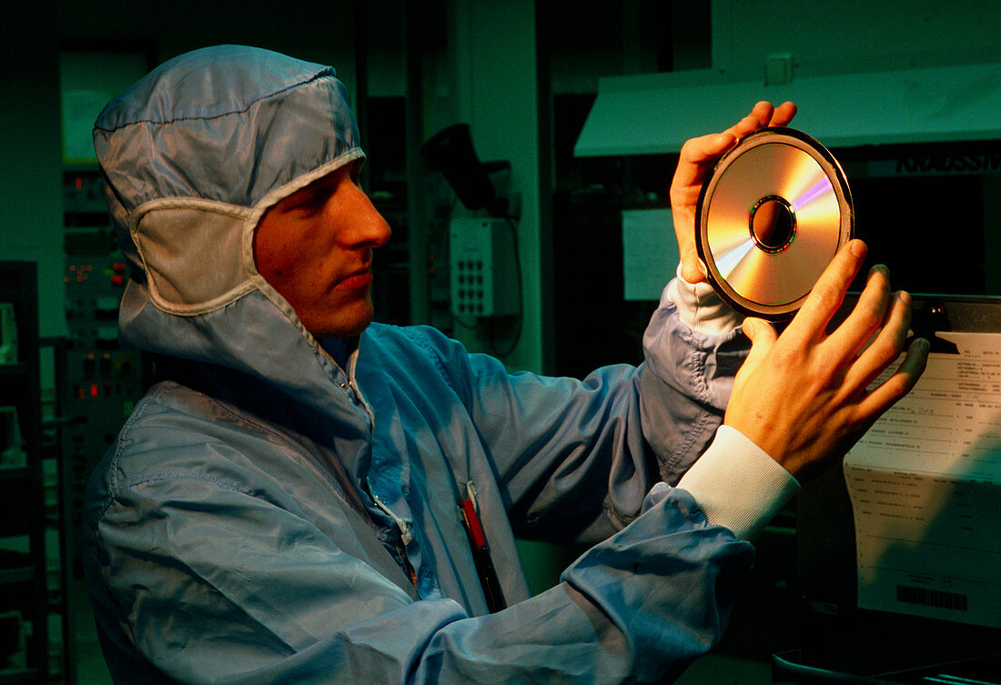 Technician visually inspects a compact disc