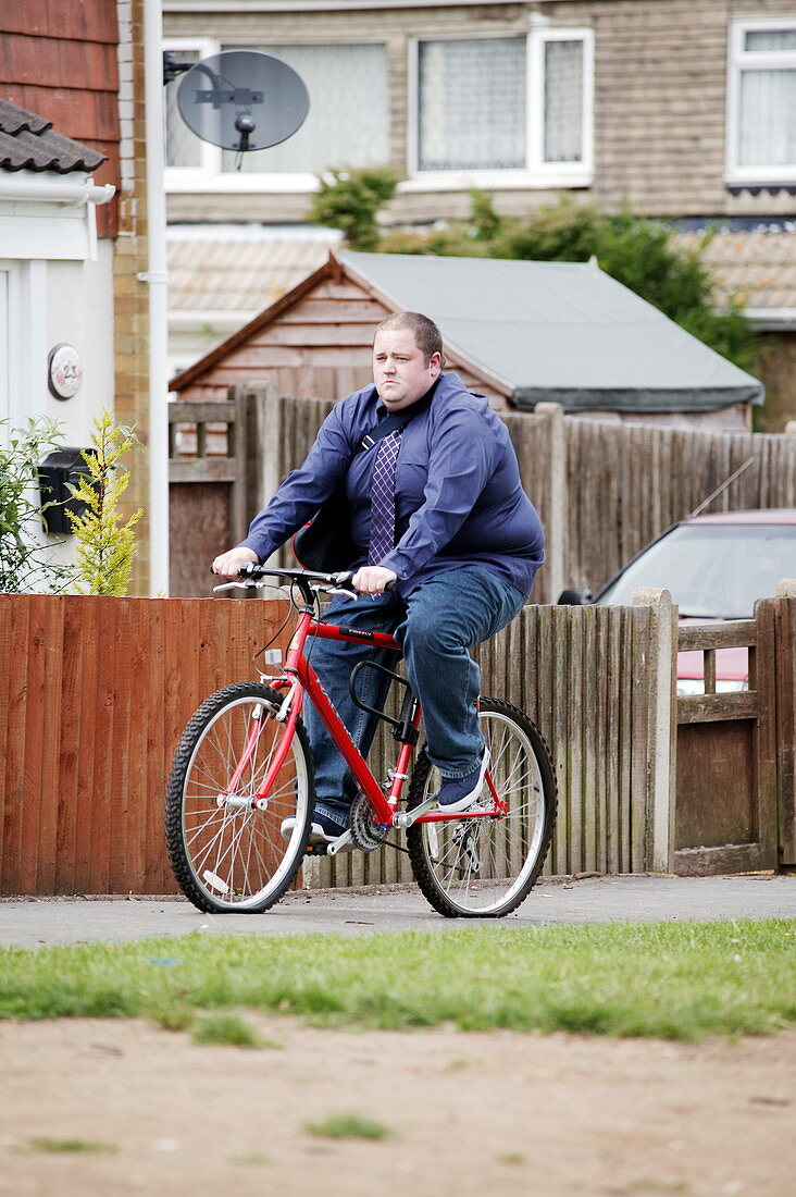 Overweight man cycling
