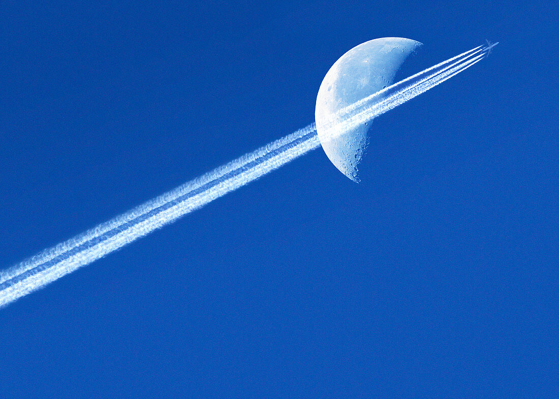 Aeroplane contrail against the Moon