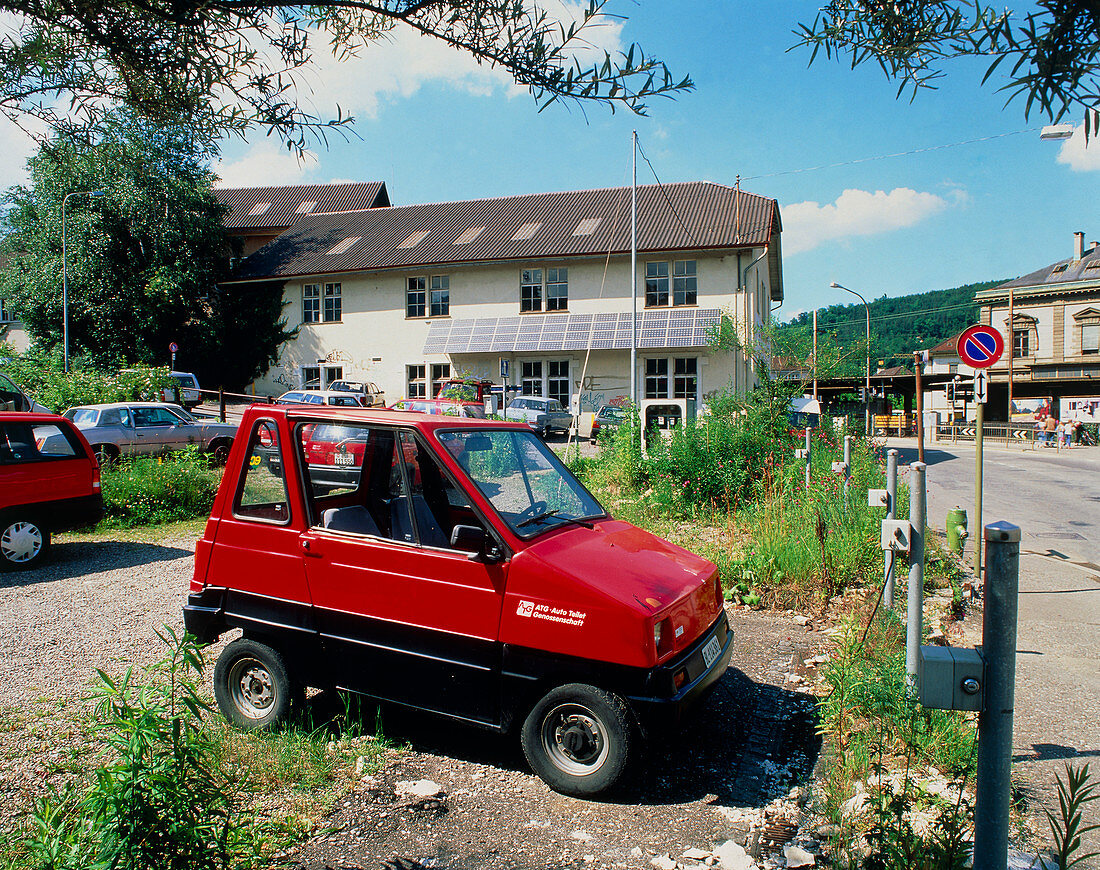 Electric car recharging its batteries at car park