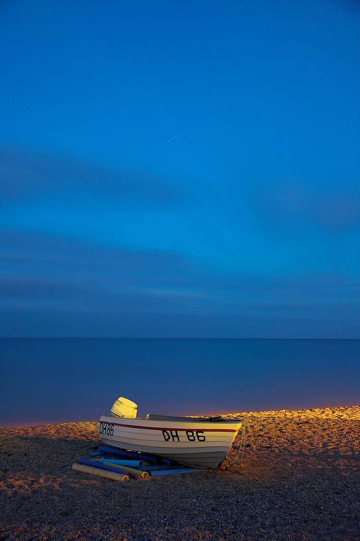 Boat moored on a beach at dusk