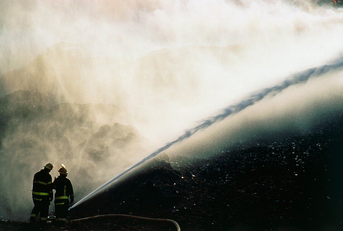 Firefighters extinguishing a ground fire