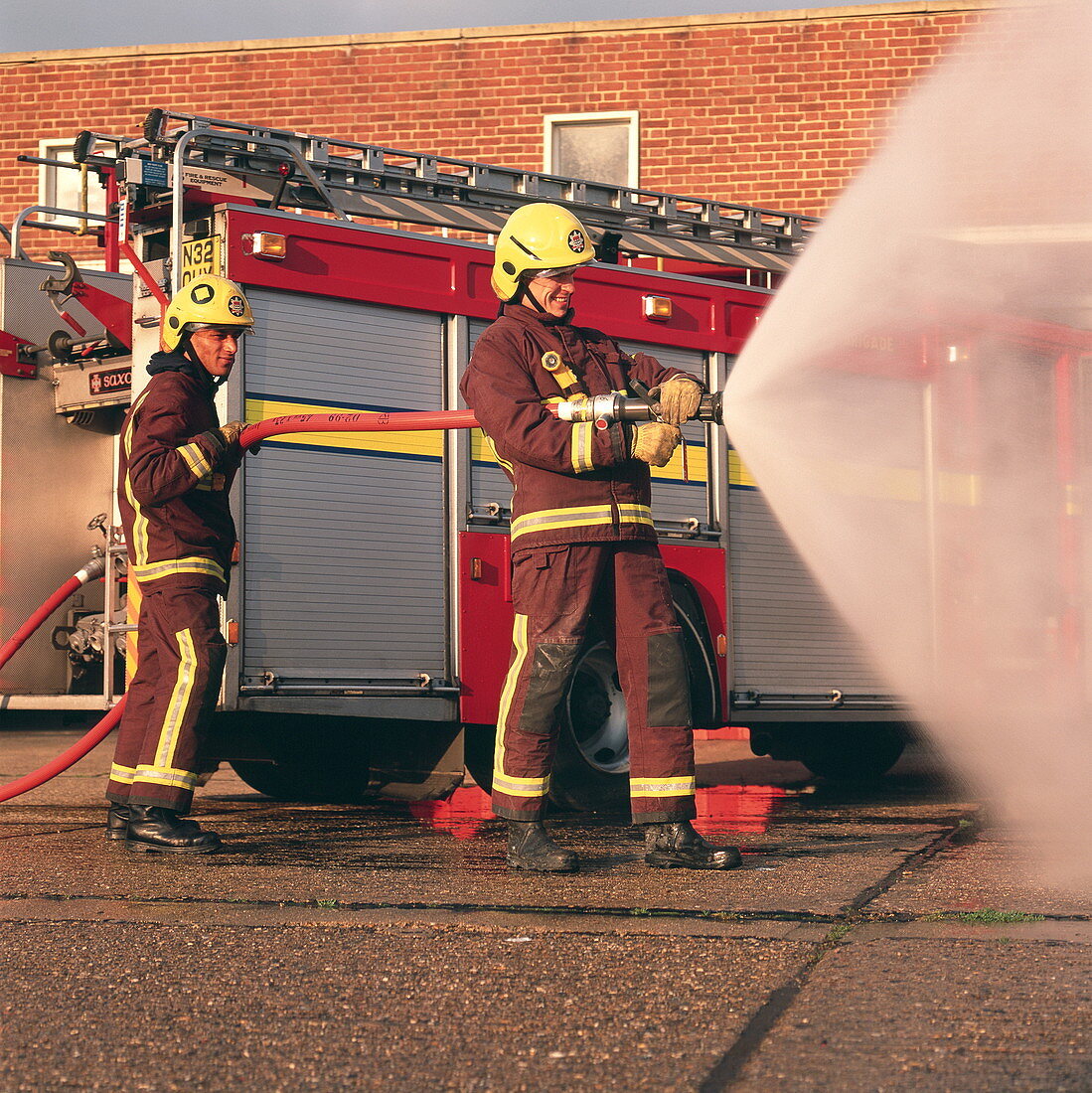 Firefighters using hose