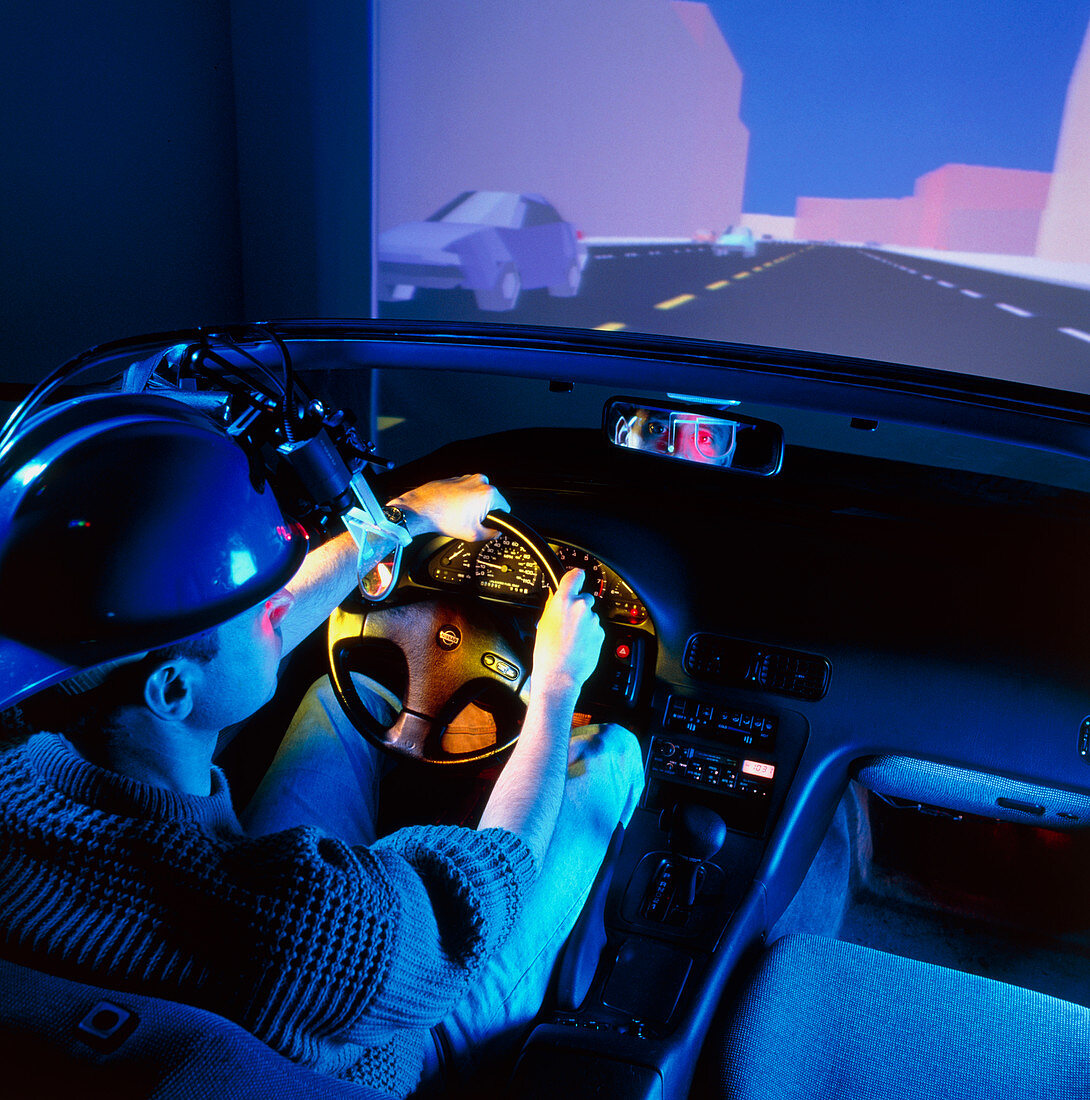 Man uses a car driving simulator