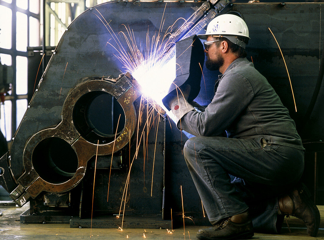 Man welding a rolling mill equipment gearbox