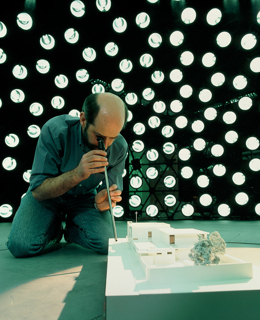 Technician examines model under artificial sky