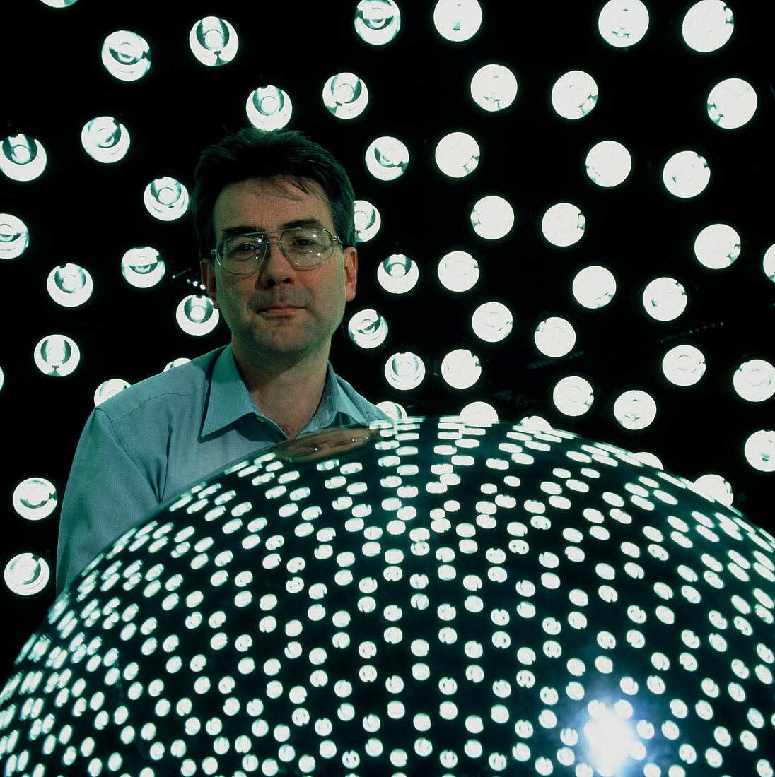 Technician examines model under artificial sky