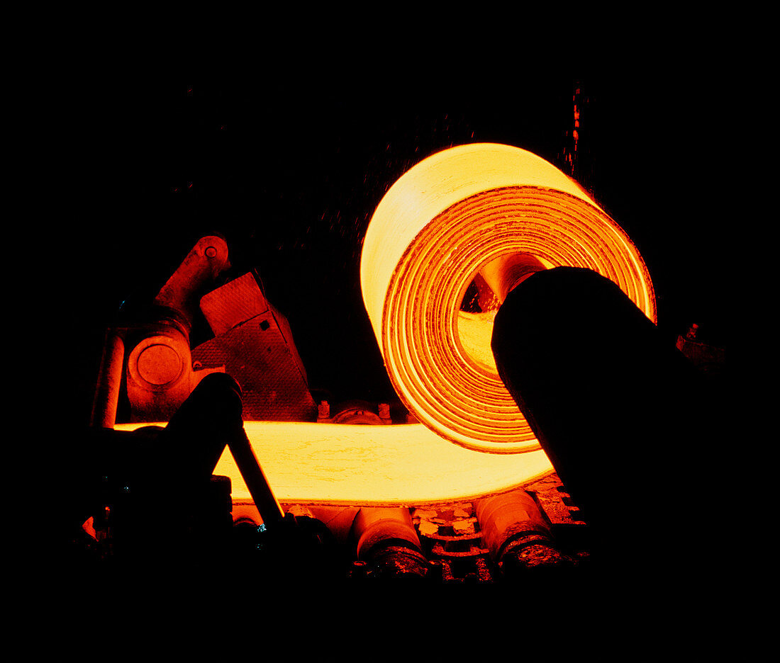 Red-hot coil of sheet steel in a rolling mill