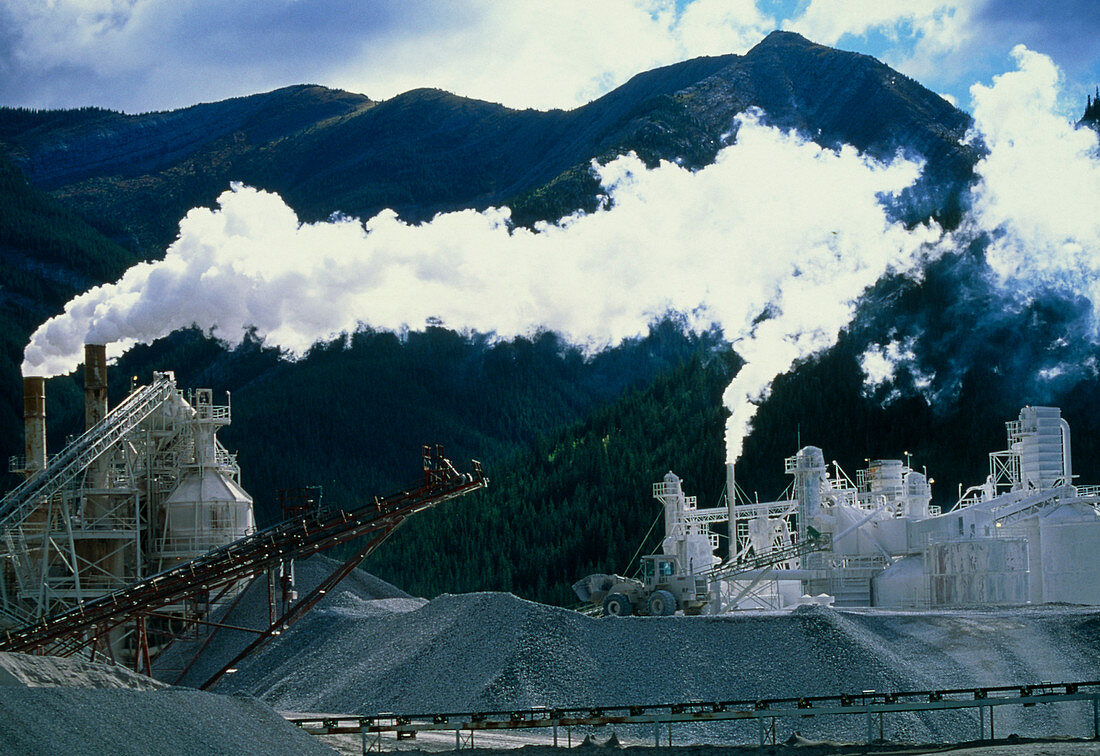 Cement works with smoke coming from its chimneys