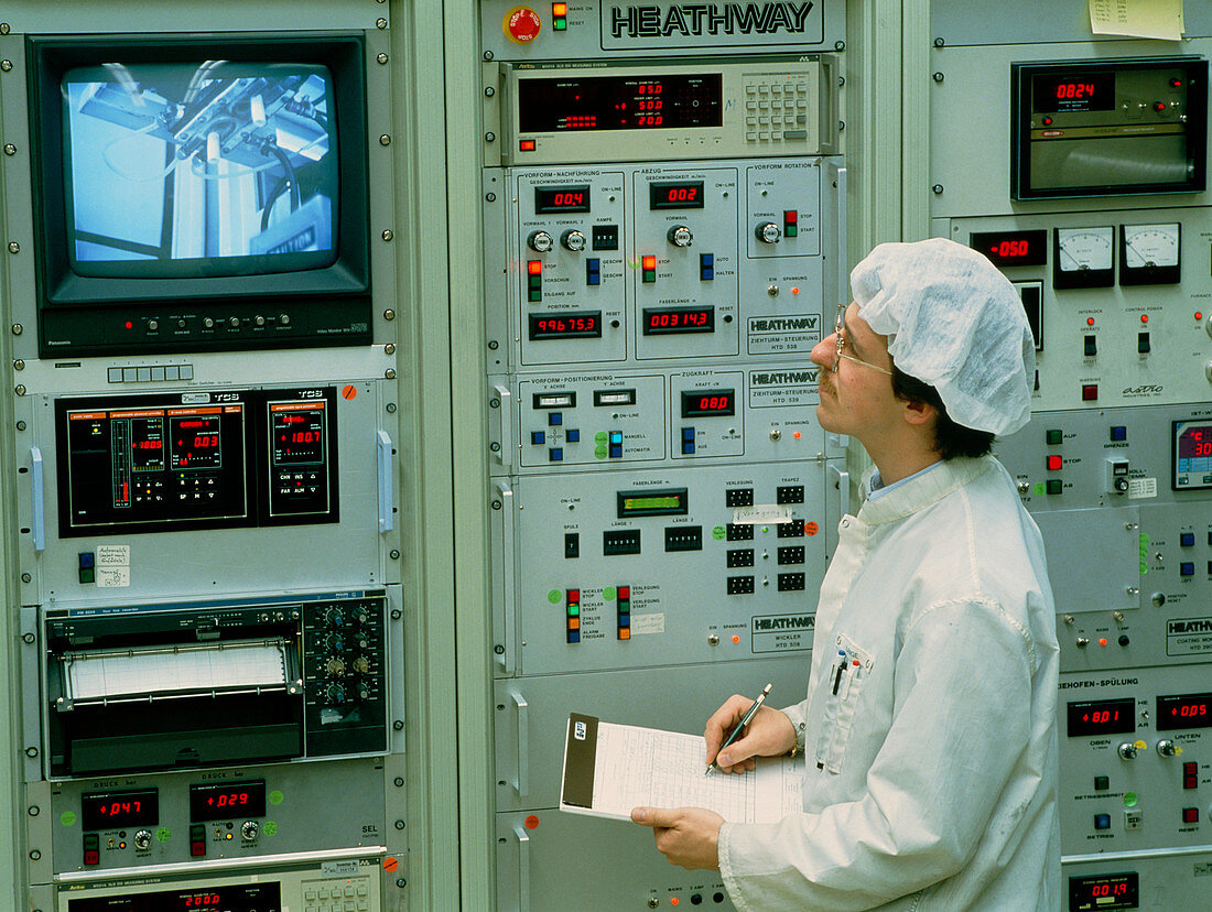 Worker & control panel in an optical fibre factory