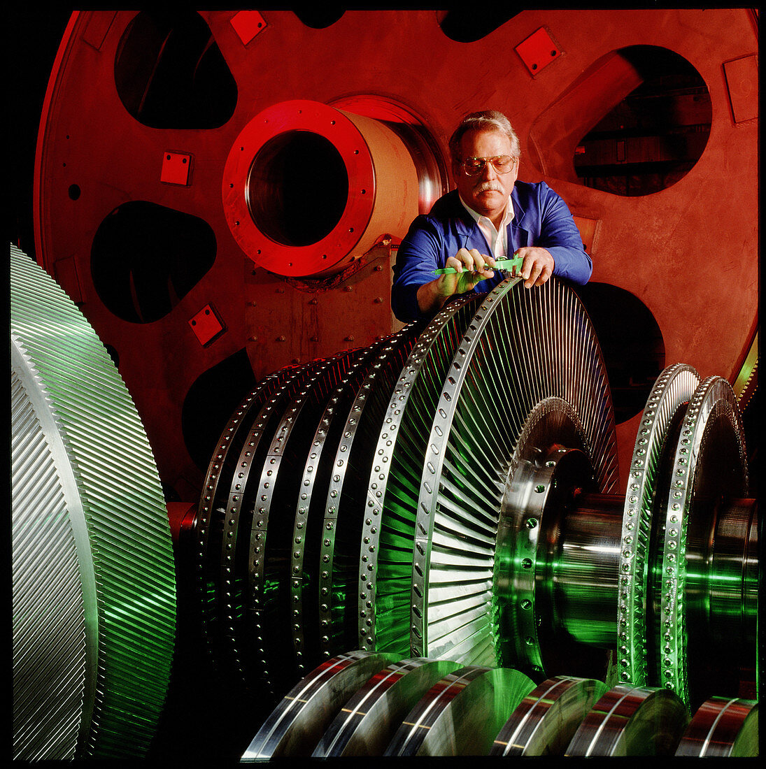 Engineer measuring part of a ship engine turbine