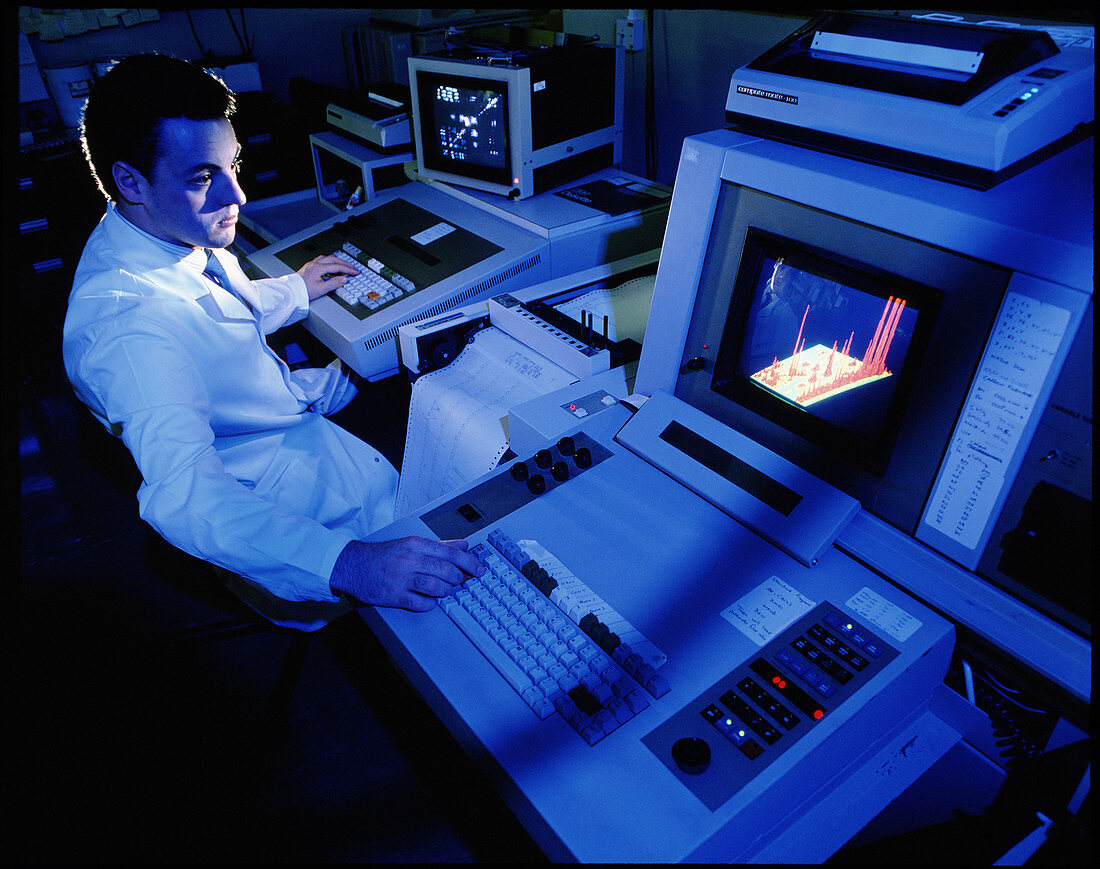 Scientist with NMR spectrometer & display