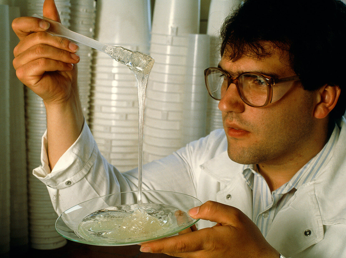 Scientist looks at a solidifying plastic resin