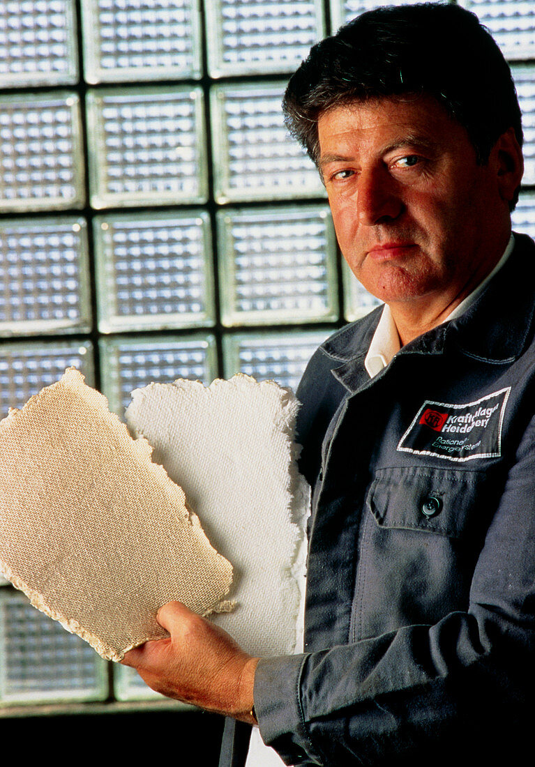 Technician showing paper after & before bleaching
