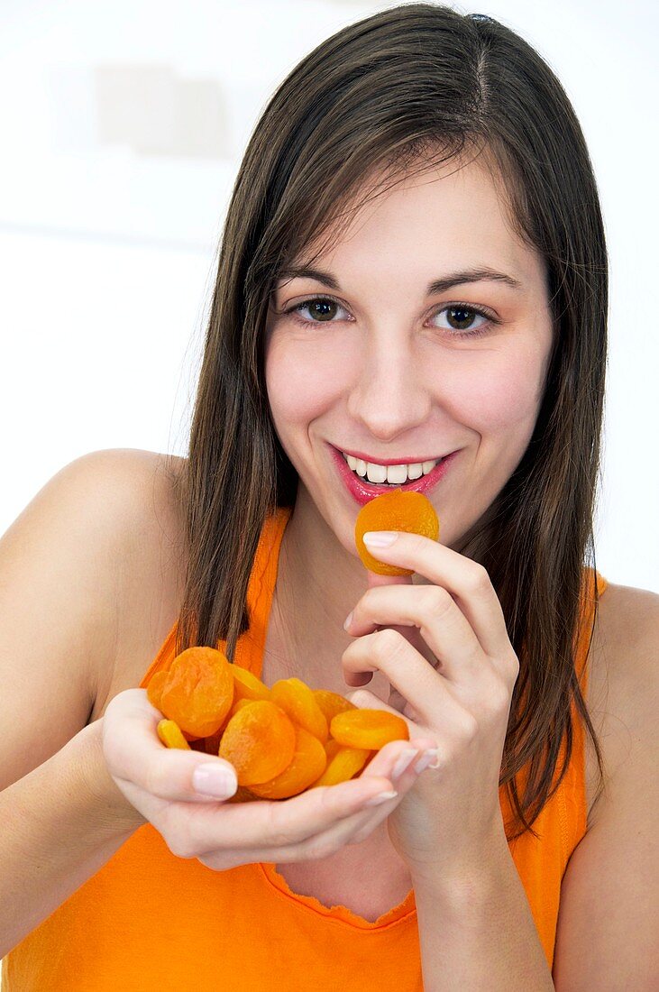 Woman eating dried apricots