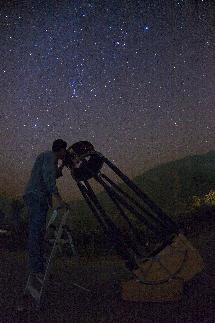 Observer using a Dobsonian telescope
