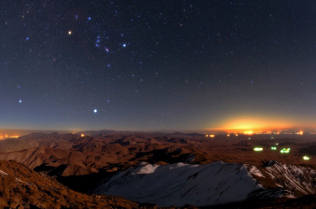 Orion and Sirius over city lights,Iran