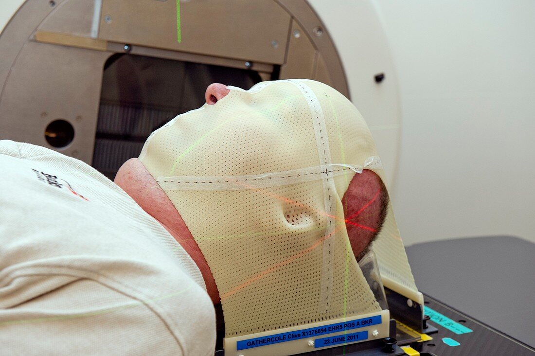 Masked patient undergoes radiotherapy